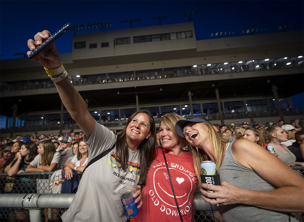 Women taking selfie at concert