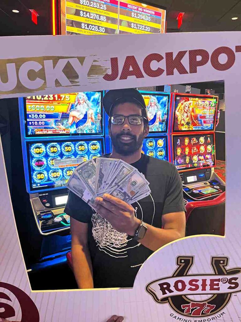 Picture of recent jackpot winner, Kumar with a frame around him that says lucky jackpot.